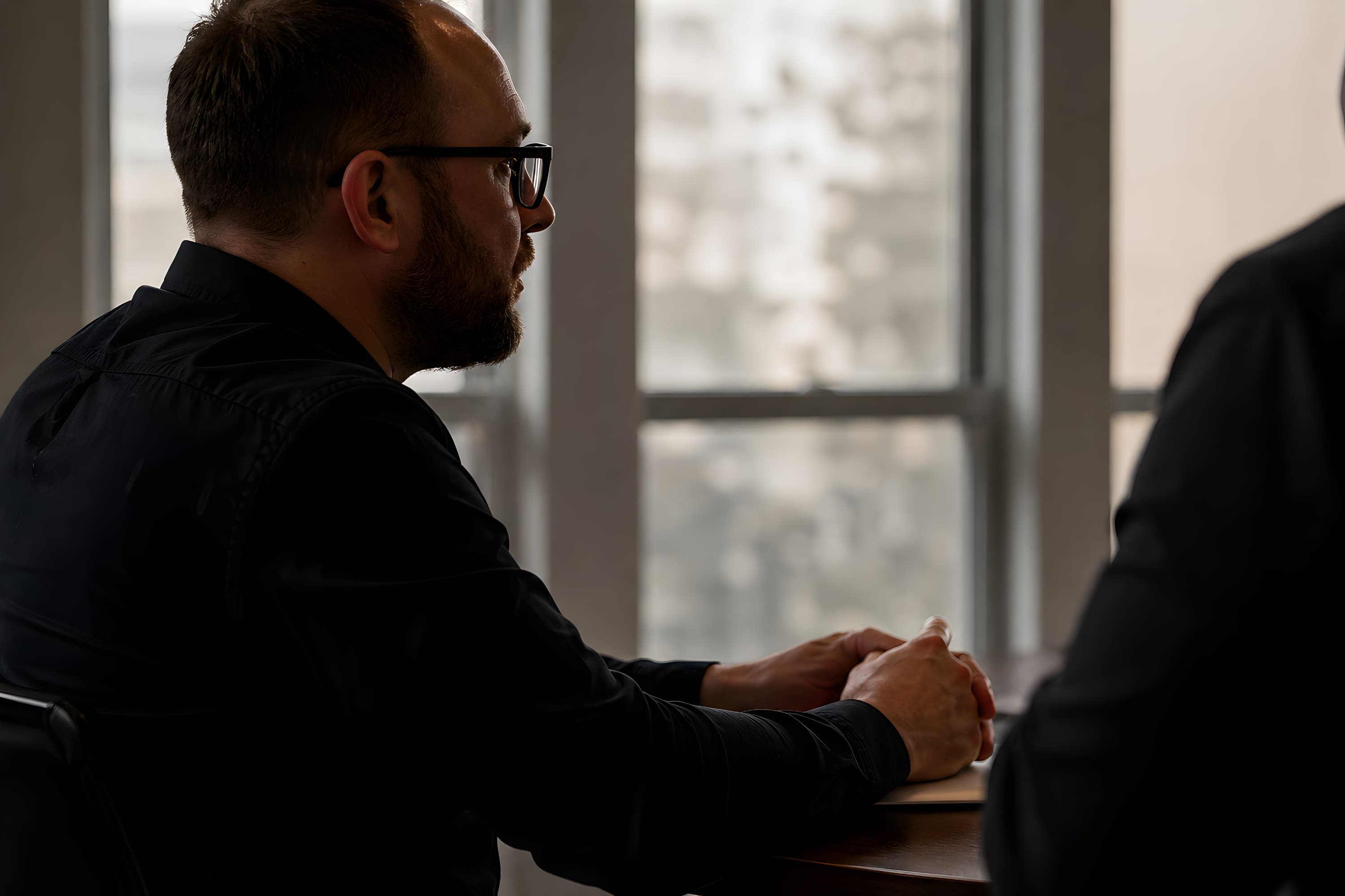 Thom Van Dycke in a working session with a client at a desk