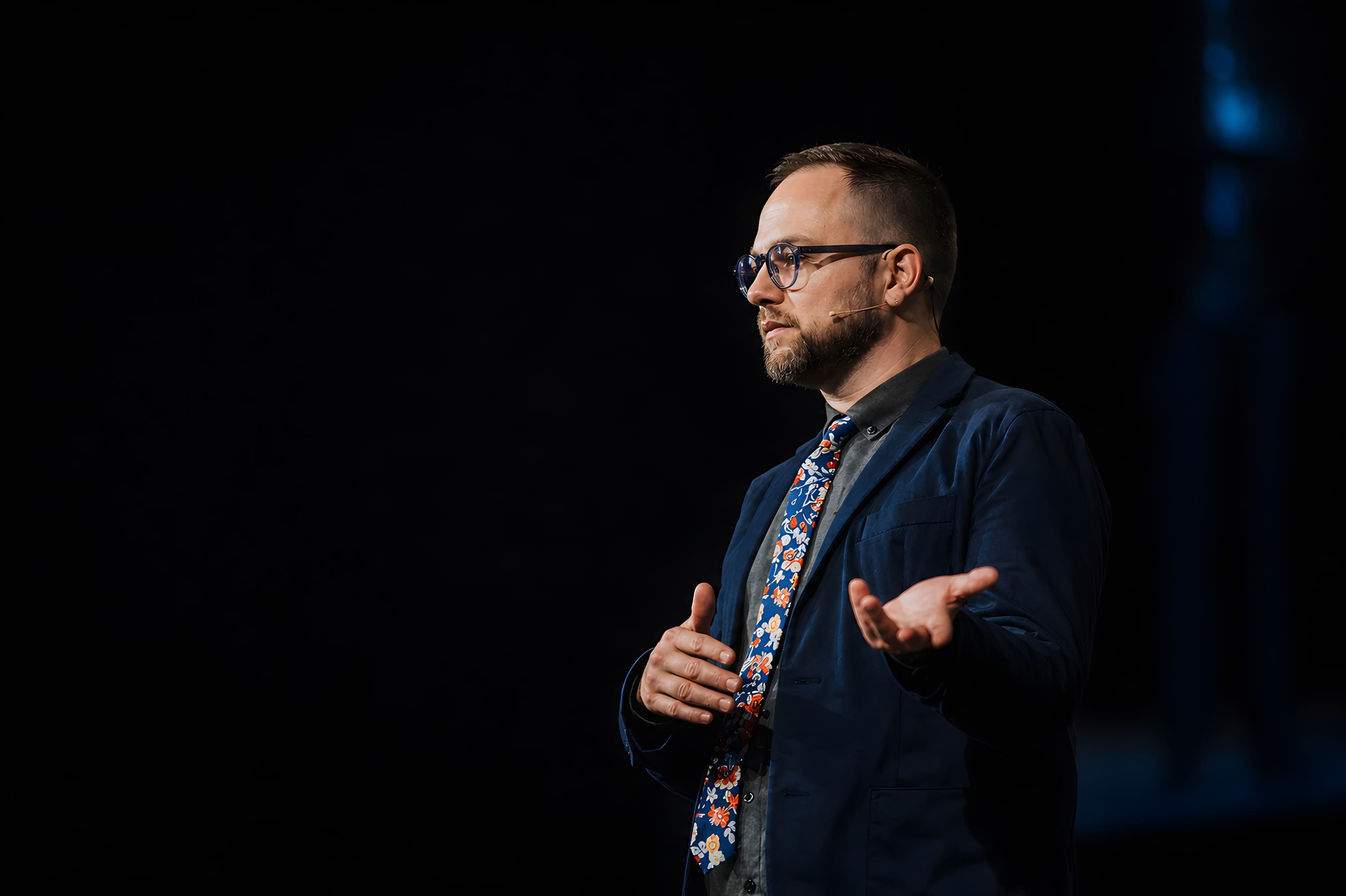 Thom Van Dycke speaking on stage